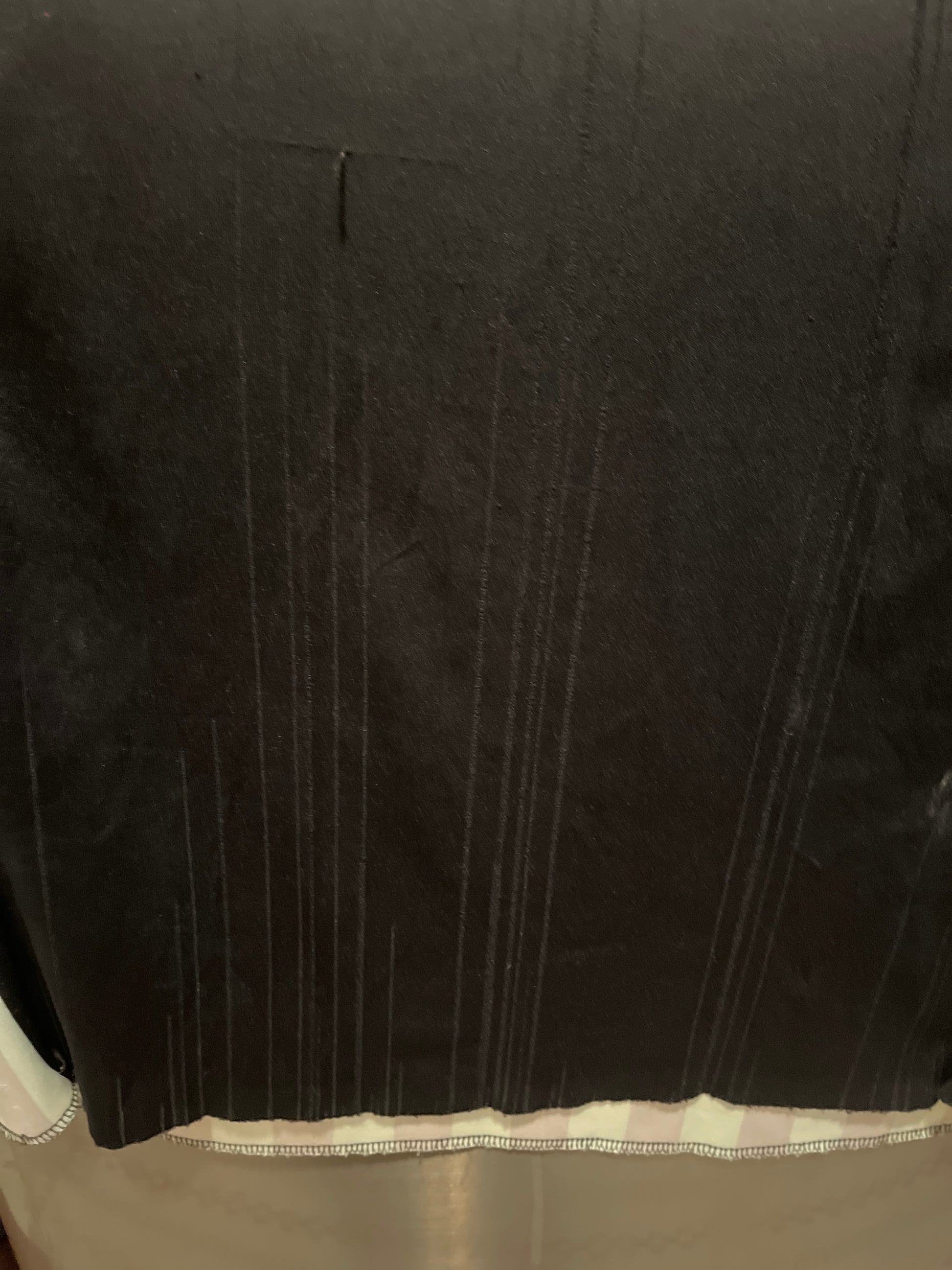 Close-up of a black fabric with visible fabric fraying