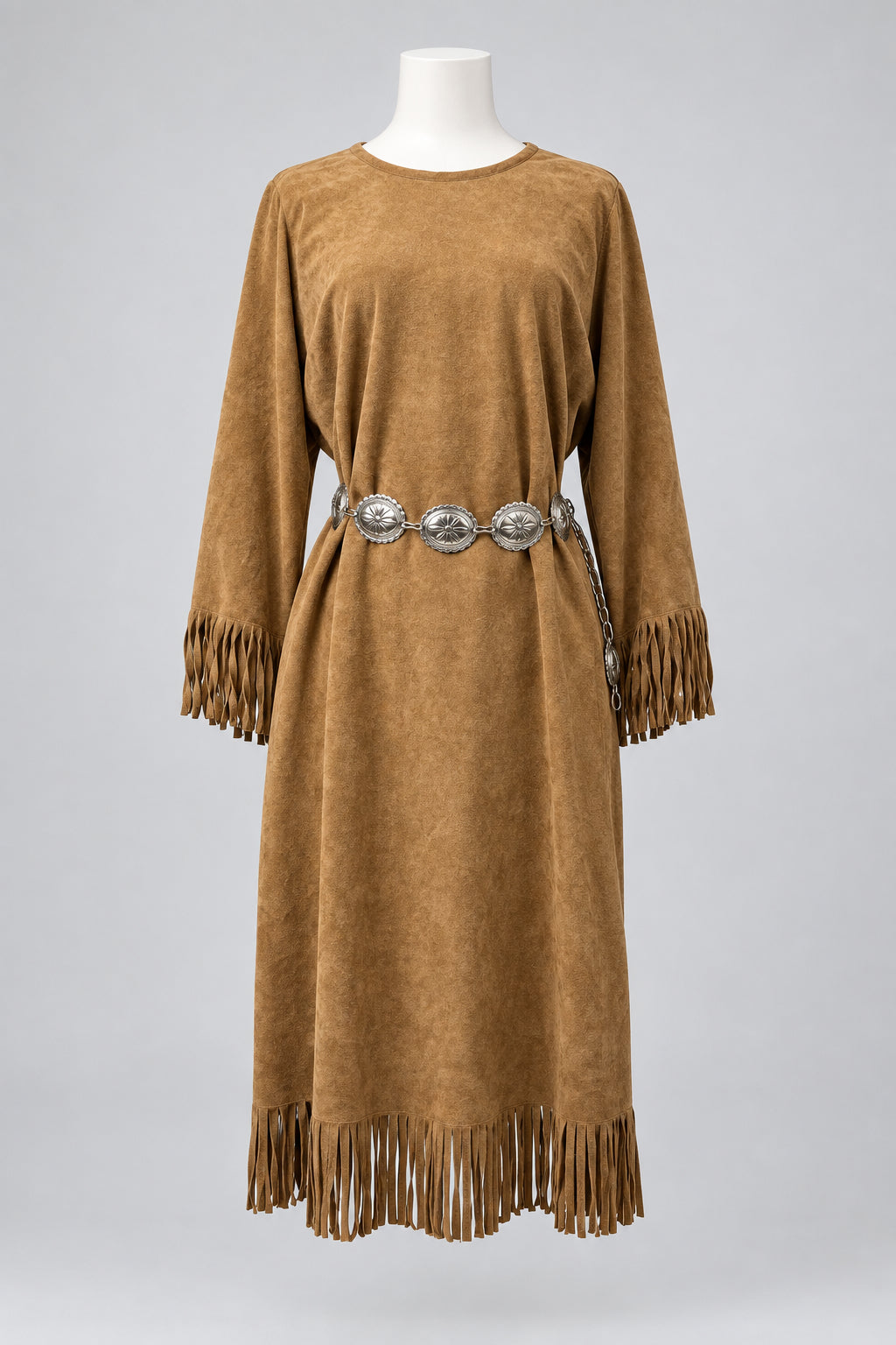 A tan suede long-sleeve dress with fringe trim and a decorative silver-toned belt, displayed on a mannequin 