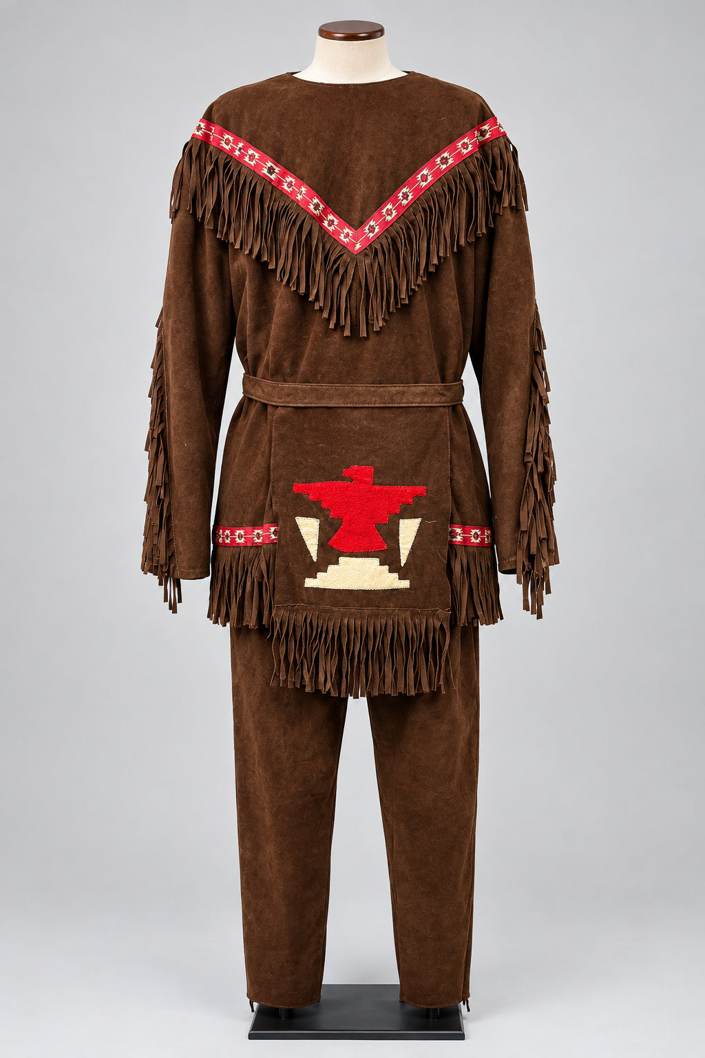 A brown faux-suede fringed costume set  The set includes a long-sleeve top with red and white patterned trim and fringe, matching pants, and a waist pouch decorated with a red and beige graphic.